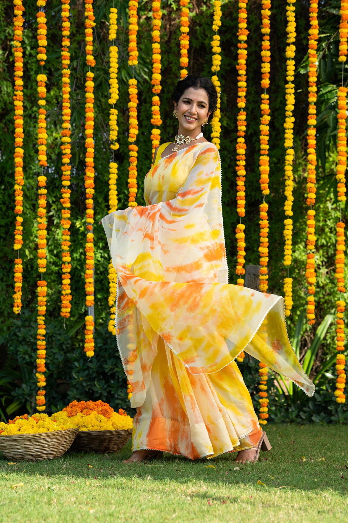 Young beautiful Indian woman in yellow chiffon saree posing near the tree  in a park 24753156 Stock Photo at Vecteezy